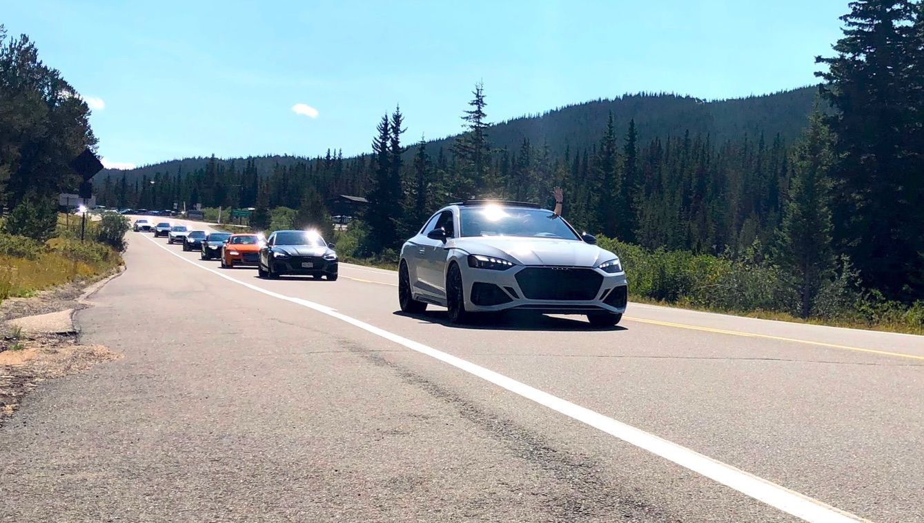 Audi Cars lined up on a drive in the mountains